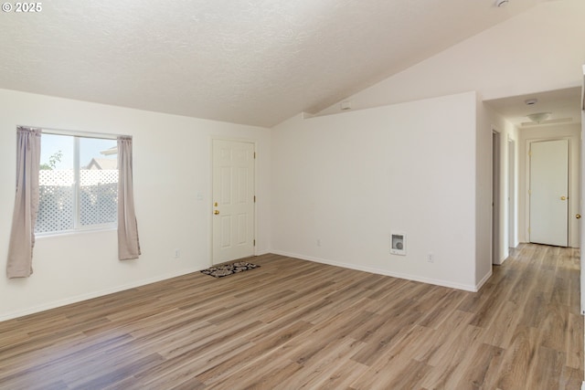 517 Anthony Dr, Boardman, OR 97818 - unfurnished room featuring light wood-style flooring, lofted ceiling, a textured ceiling, and baseboards