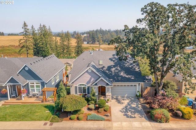 view of front of house with a front yard and a garage