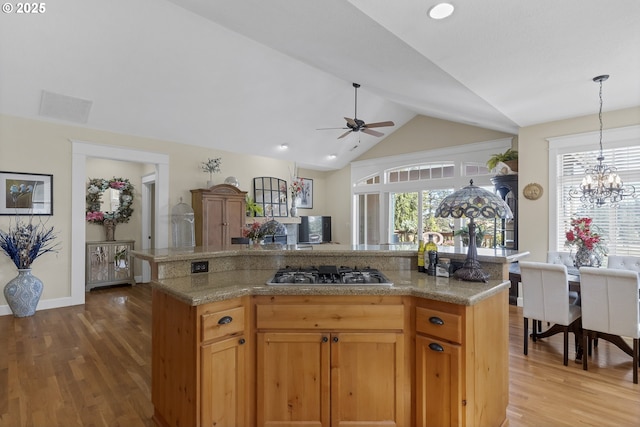 kitchen with a healthy amount of sunlight, a center island, and stainless steel gas stovetop