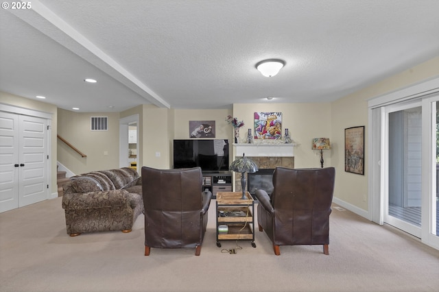 carpeted living room featuring a textured ceiling