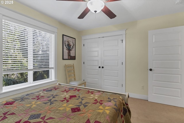 bedroom with carpet floors, ceiling fan, and a closet