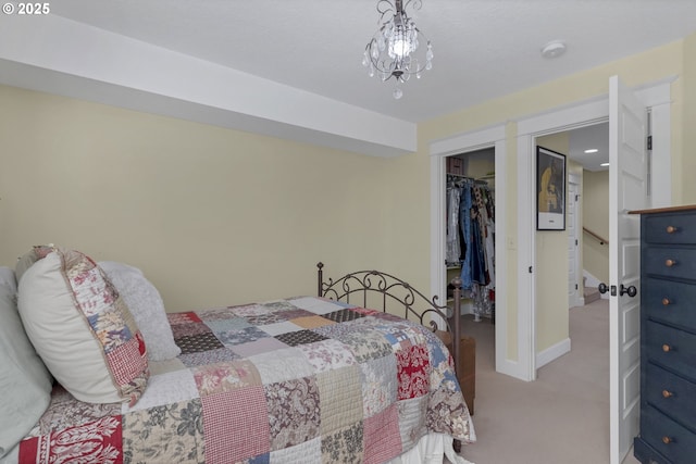 bedroom with a walk in closet, light colored carpet, and a closet