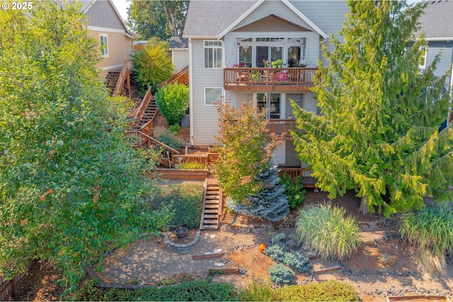 rear view of property featuring a balcony