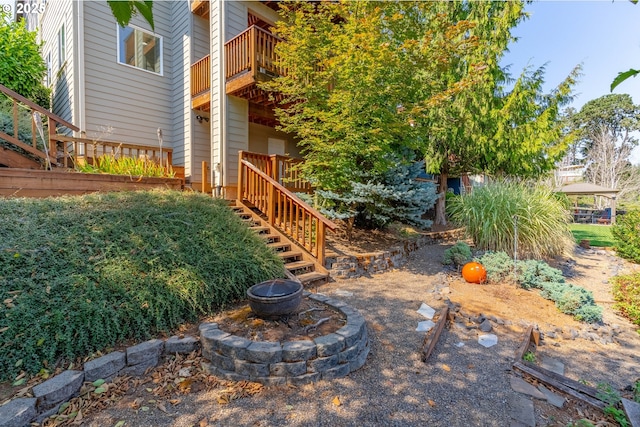 view of yard with a balcony and a fire pit