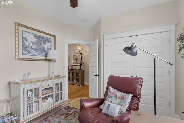 sitting room featuring ceiling fan and light hardwood / wood-style flooring