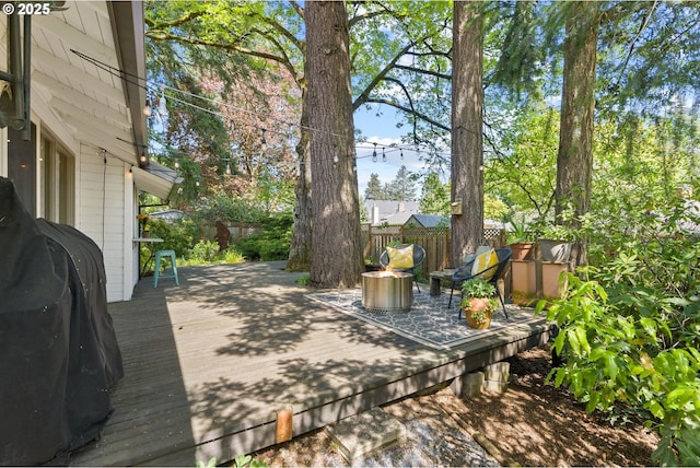 wooden deck featuring a fenced backyard