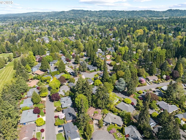 bird's eye view featuring a residential view and a wooded view
