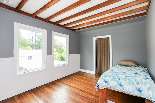 22621 Noti Loop, Noti, OR 97461 - bedroom with beam ceiling, a wainscoted wall, and hardwood / wood-style flooring