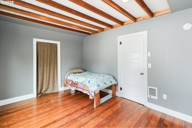 22621 Noti Loop, Noti, OR 97461 - bedroom featuring beamed ceiling, wood finished floors, baseboards, and heating unit