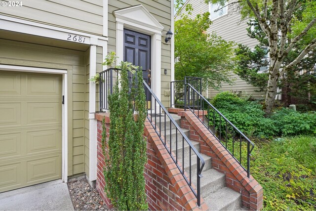 view of exterior entry featuring a garage
