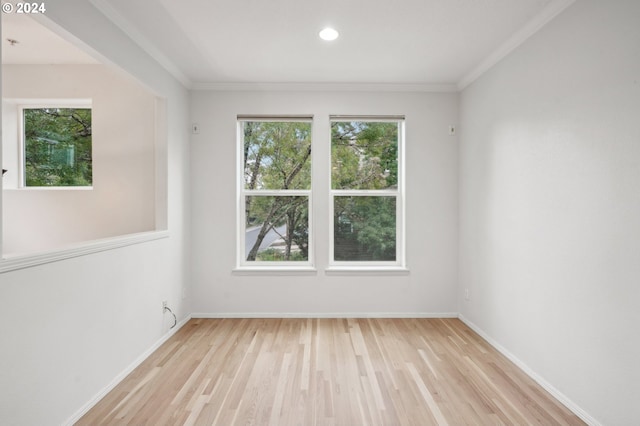 empty room with baseboards, wood finished floors, and recessed lighting