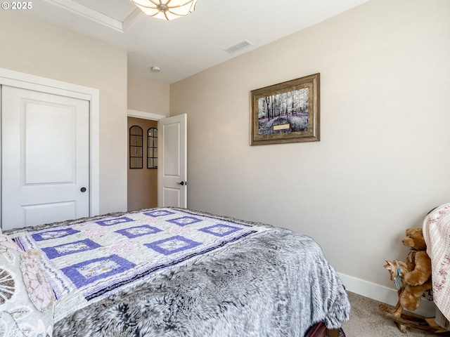 carpeted bedroom featuring baseboards and visible vents