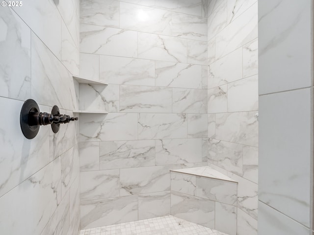 interior details with a tile shower