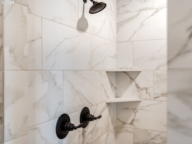 interior details with a tile shower