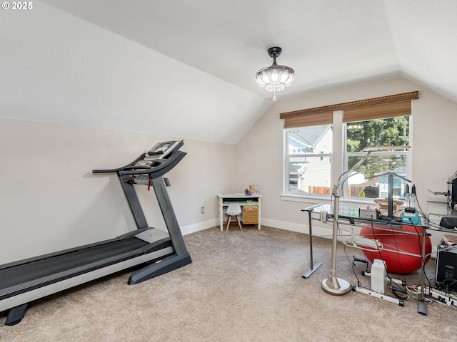 workout room with vaulted ceiling, carpet flooring, and baseboards
