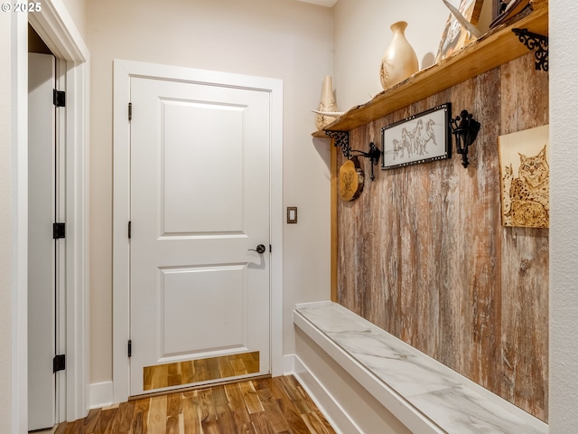 mudroom featuring baseboards and wood finished floors