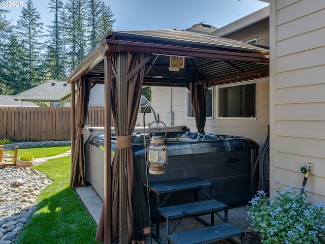 exterior space featuring a gazebo, a carport, and fence