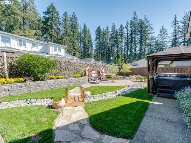 view of yard with a patio area, a fenced backyard, a gazebo, and a hot tub