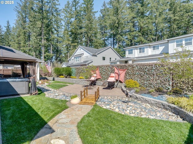 view of yard featuring fence, a patio area, a gazebo, and a hot tub