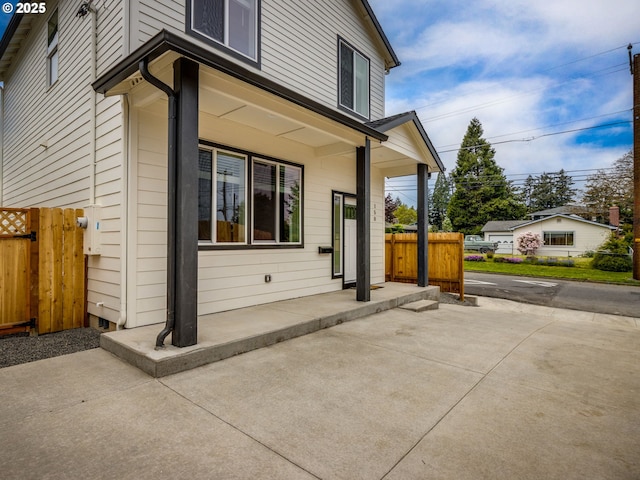 rear view of house with a patio area and fence