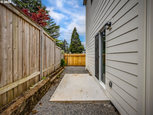 view of side of home with a fenced backyard and a patio area