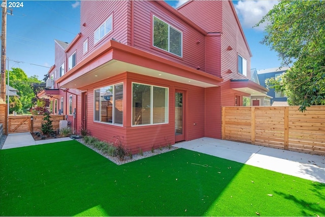 rear view of property featuring a yard