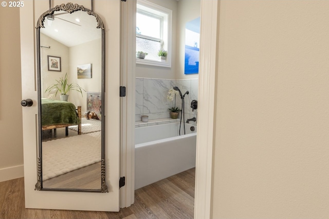 interior space featuring vaulted ceiling and wood finished floors