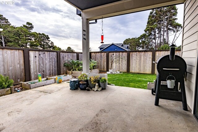 view of patio / terrace with a garden and a fenced backyard