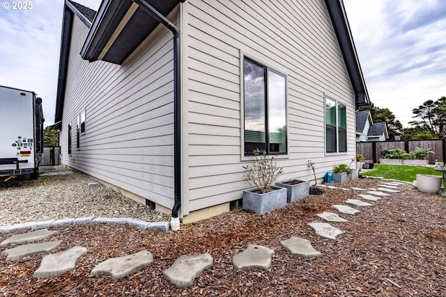 view of property exterior featuring fence