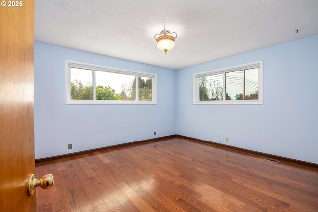 unfurnished room featuring wood-type flooring