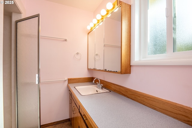 bathroom featuring vanity and an enclosed shower