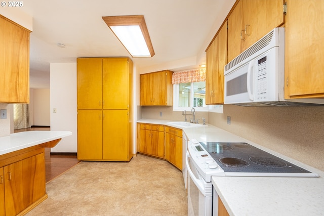 kitchen with white appliances, sink, and backsplash