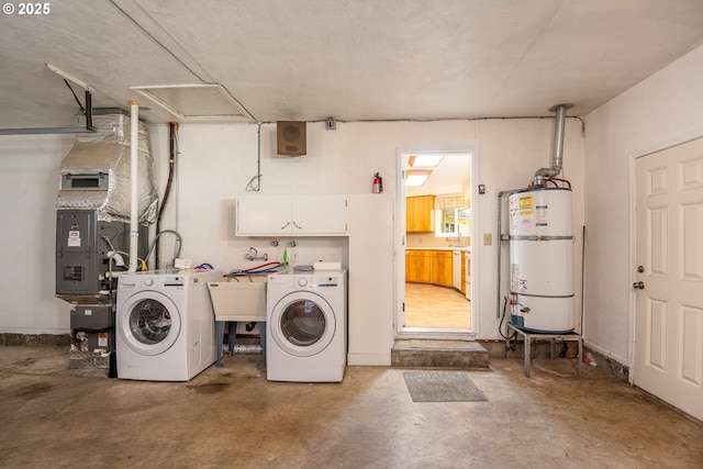 laundry room featuring heating unit, secured water heater, washer and clothes dryer, and cabinets