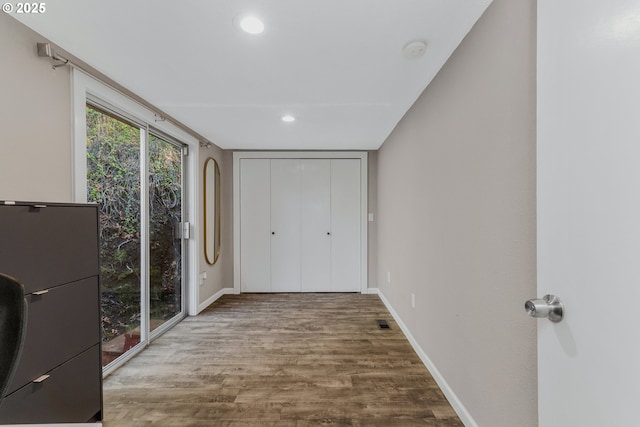 unfurnished bedroom featuring hardwood / wood-style floors and a closet