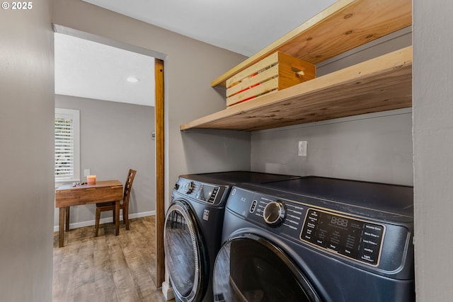 clothes washing area with separate washer and dryer and wood-type flooring