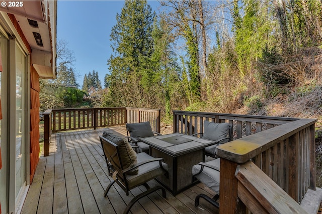 wooden terrace with a fire pit