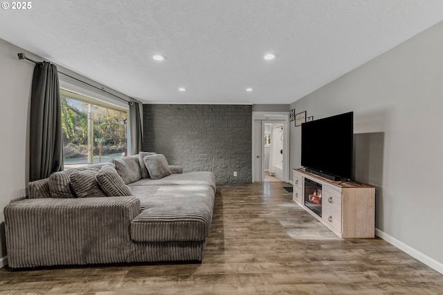 living room with hardwood / wood-style flooring and a textured ceiling