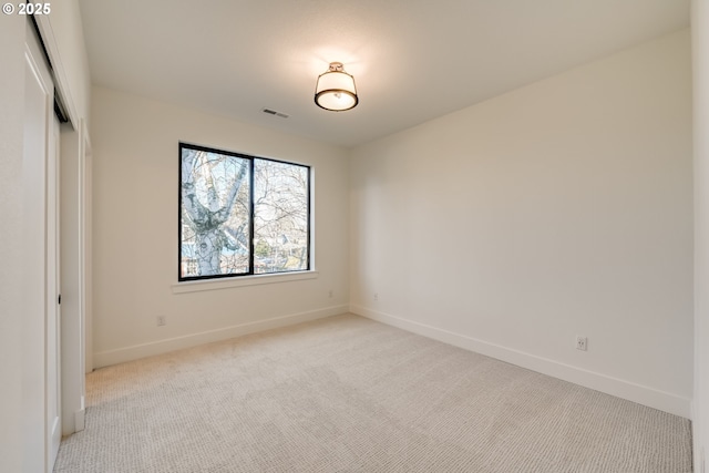 unfurnished bedroom featuring baseboards, a closet, and light colored carpet