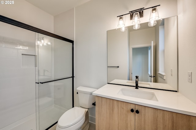 bathroom featuring toilet, a stall shower, and vanity