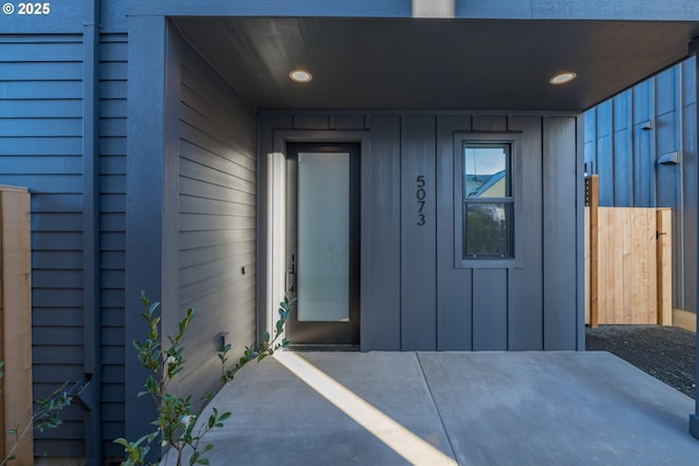 view of exterior entry with board and batten siding