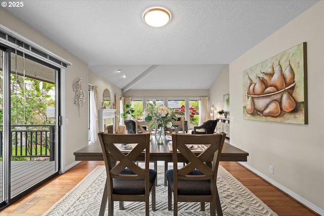 31560 SW Arbor Glen Loop, Wilsonville, OR 97070 - dining area with baseboards, light wood finished floors, lofted ceiling, and a healthy amount of sunlight