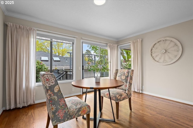 31560 SW Arbor Glen Loop, Wilsonville, OR 97070 - dining room with baseboards, ornamental molding, and wood finished floors