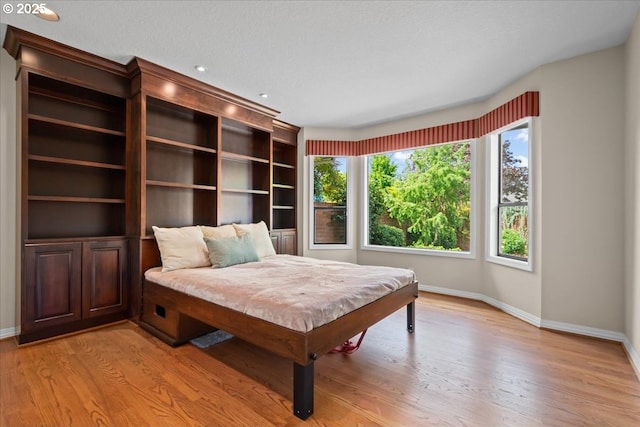 31560 SW Arbor Glen Loop, Wilsonville, OR 97070 - bedroom featuring baseboards and light wood-style flooring
