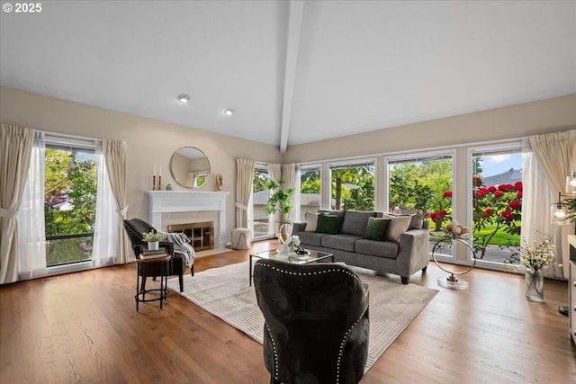 31560 SW Arbor Glen Loop, Wilsonville, OR 97070 - living room with wood finished floors, a fireplace with flush hearth, beam ceiling, and a wealth of natural light