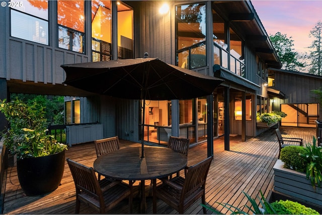 deck at dusk with outdoor dining area