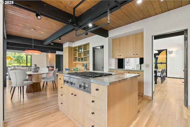 kitchen with light brown cabinets, wooden ceiling, light wood-style floors, a center island, and stainless steel gas cooktop