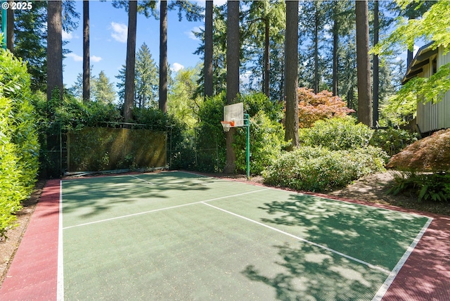 view of basketball court with basketball court and fence