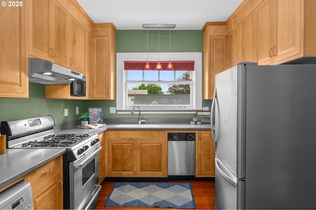 2083 NW Johnson St Unit 45, Portland, OR 97209 - kitchen featuring stainless steel appliances, under cabinet range hood, a sink, and dark wood finished floors