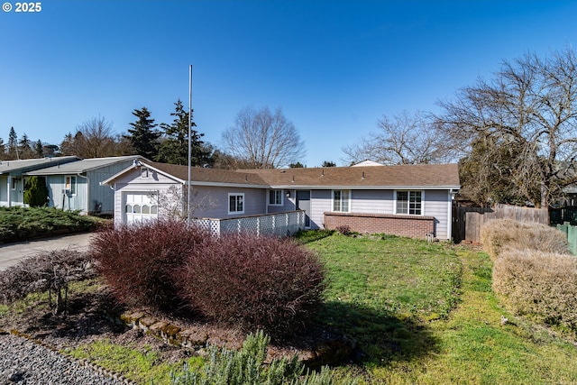 ranch-style home featuring a garage, a front lawn, driveway, and fence