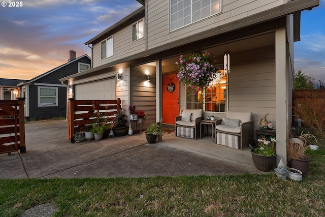 exterior space with a garage, fence, and concrete driveway